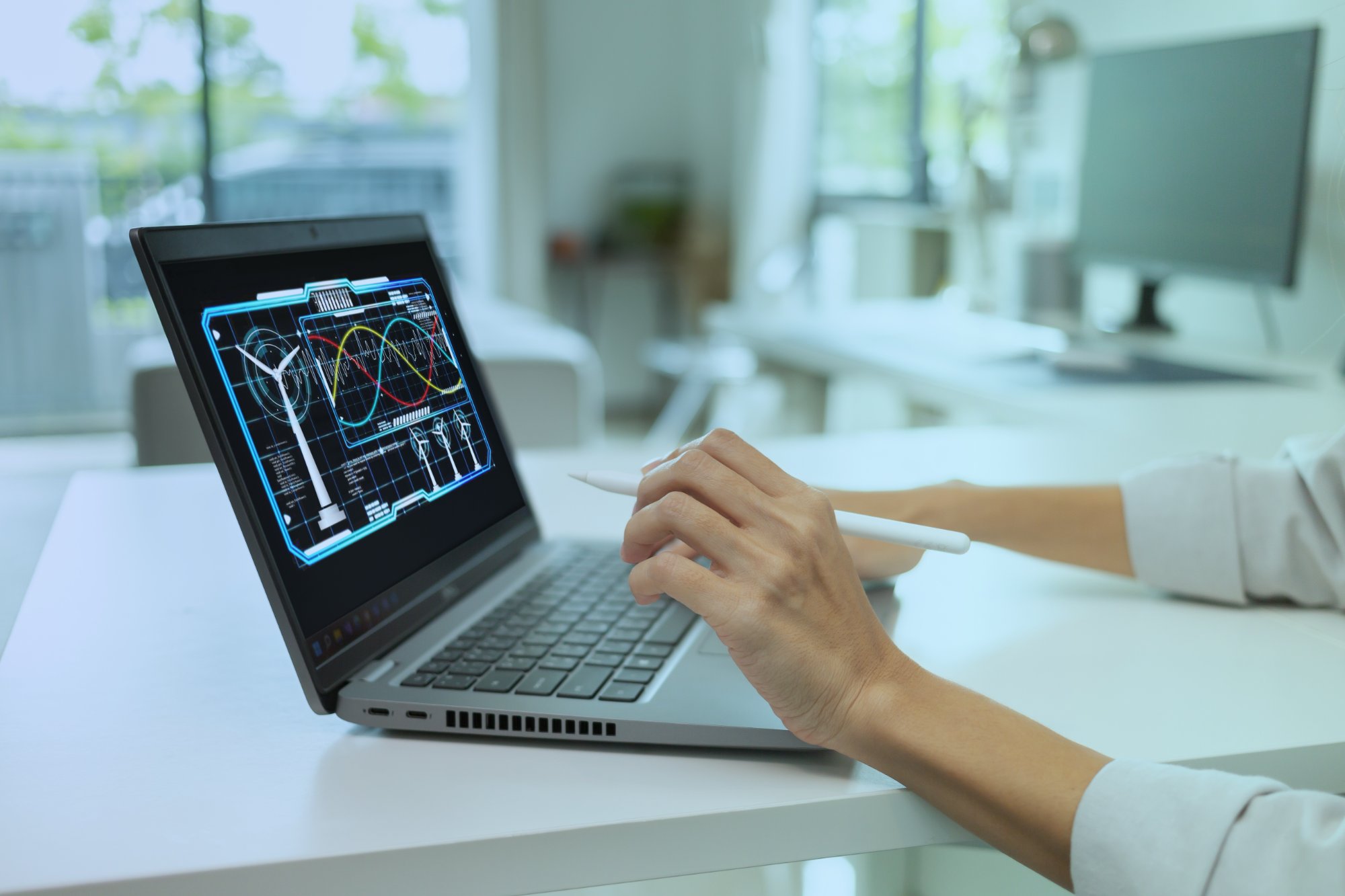 Engineer analyzing performance curves on laptop screen